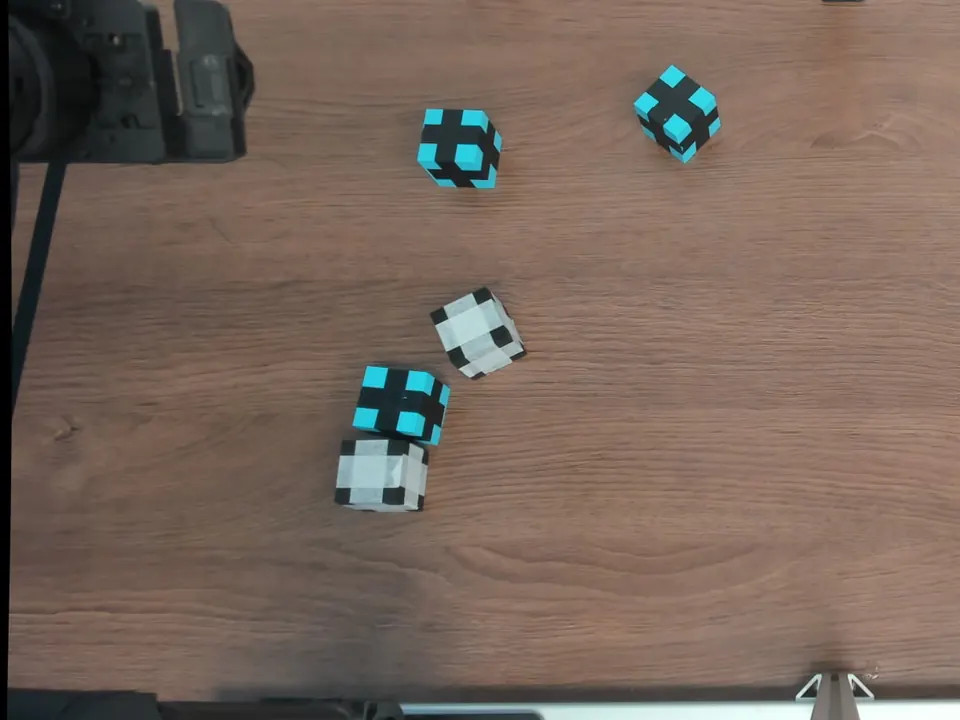 Overhead view of six cubes scattered across the table.