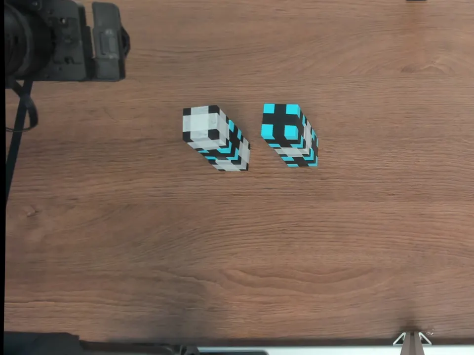 Overhead photograph of two completed three-cube towers.
