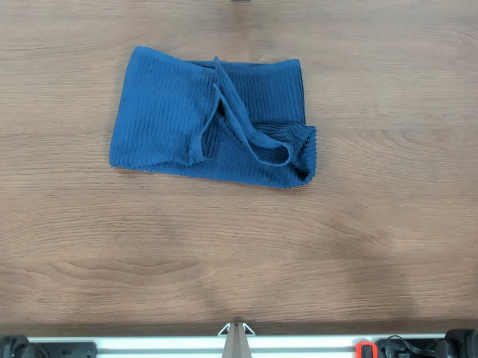 Overhead photograph of a folded towel with an unfolded triangular corner.